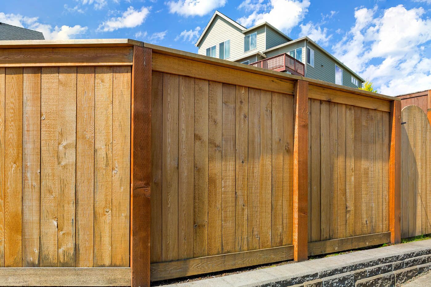 A beautiful wooden fence installed by the experts at 76 FENCE - install your cedar fencing today.
